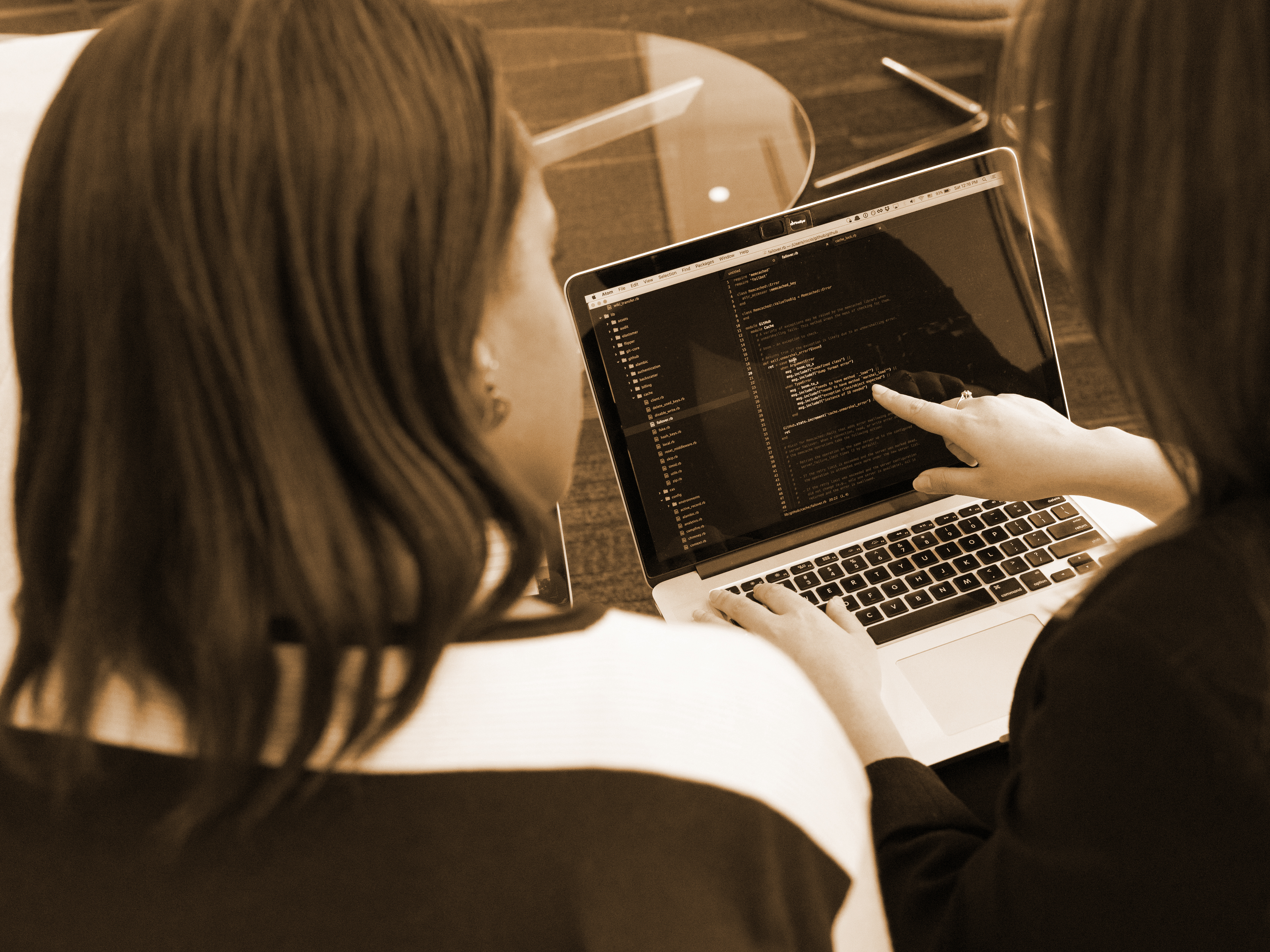 A stock photo of 2 women looking over a laptop